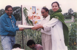 Donator of Land Shri Balkishanbhai hands over land title papers to Shri Girishbhai Patel (Managing Trustee) and Mrs Manzil Nanavaty (Trustee)